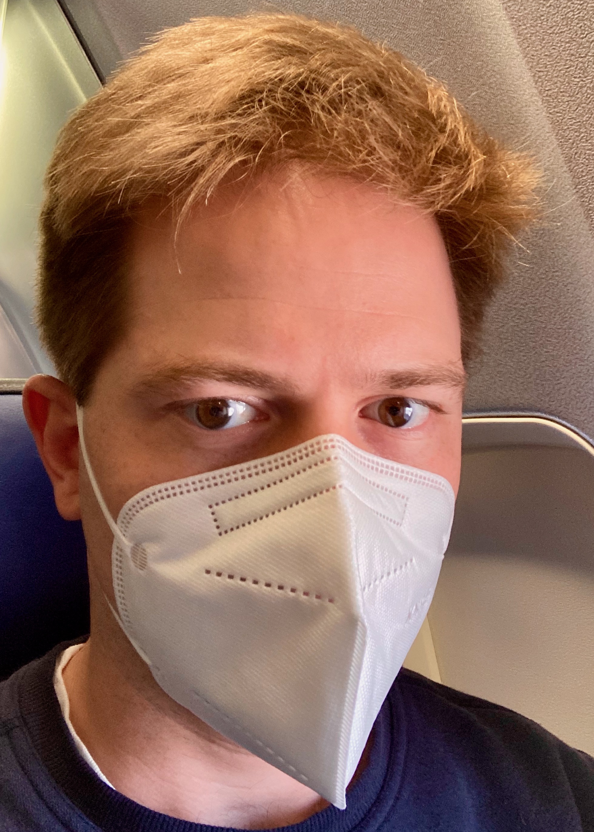 Me (Stephen Larew) wearing a snug N95 mask on the flight to Chicago O'Hare.